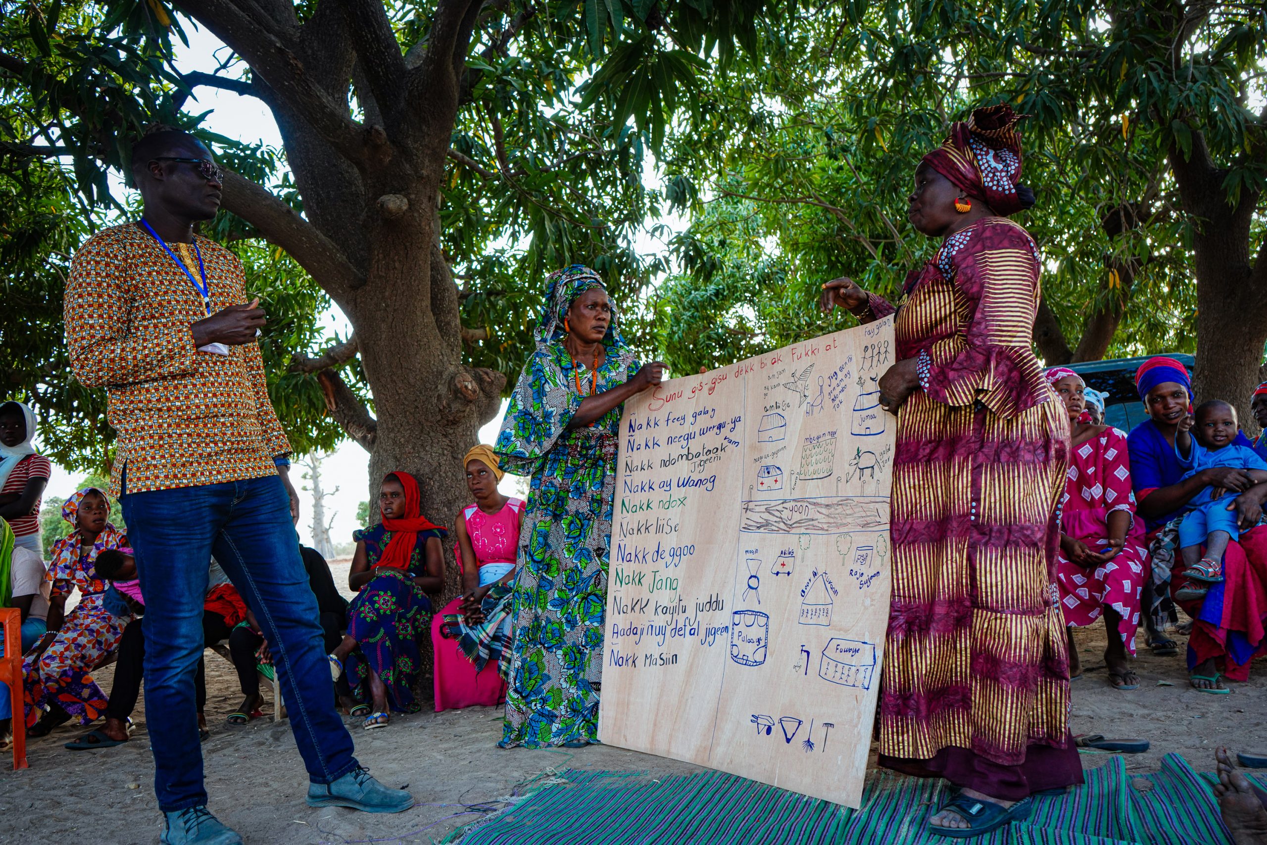 Birima Fall and women showing the vision board